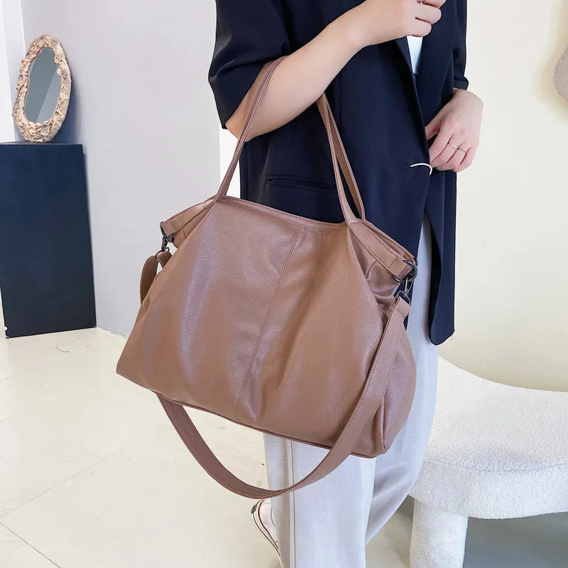 Large horizontal PU messenger bag with soft surface and shoulder strap in black colour
