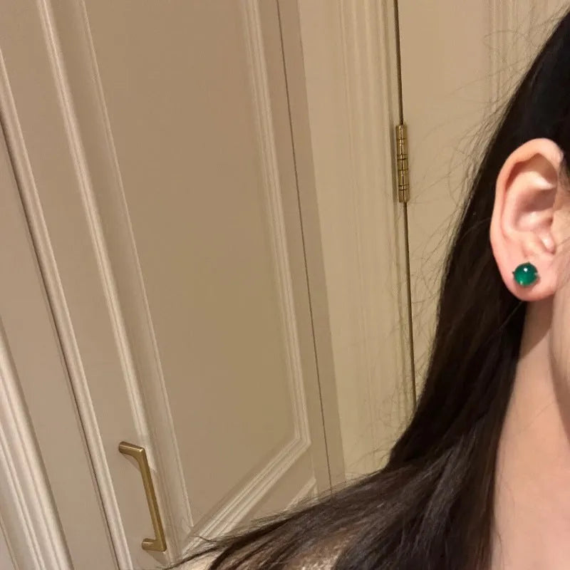 Round egg surface chalcedony stud earrings with four-claw copper setting in emerald green colour