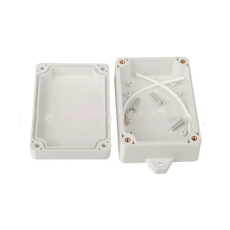 F4B-1 black ABS plastic waterproof junction box for electronic components, 100mm long.
