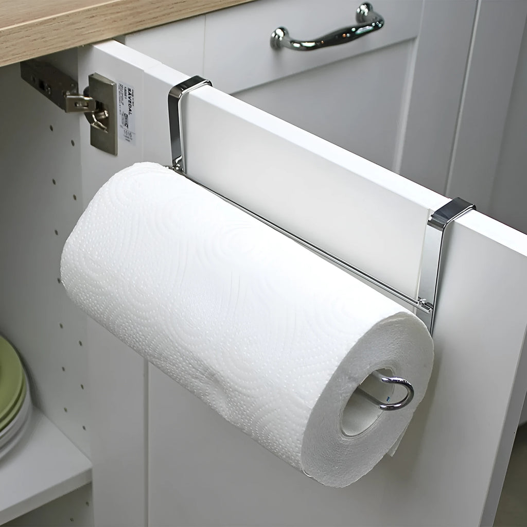 Silver stainless steel paper towel rack hanging on kitchen cabinet door