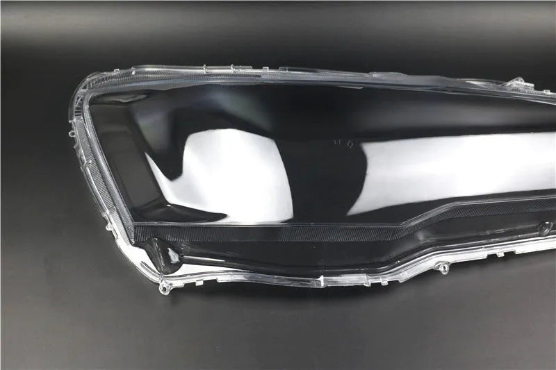 Transparent plastic headlight housing cover measuring 50mm by 30mm by 20mm