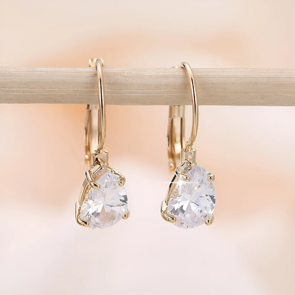 Women's drop-shaped copper earrings with gold finish and decorative platinum inlay.