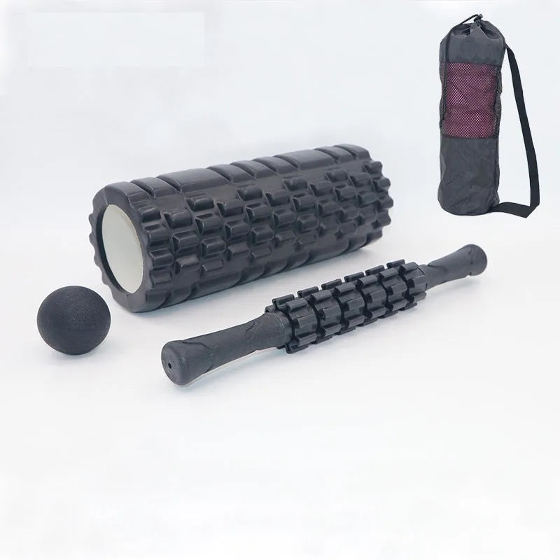 Black handheld foam massage roller bar with six white textured gear pieces on a 33cm shaft.