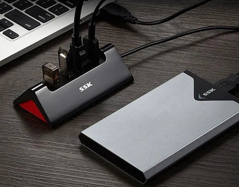 Black ABS plastic USB expansion dock with four ports and a Micro USB power connection.