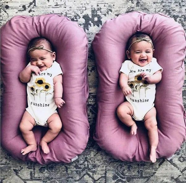 Beige portable baby nest bed crib measuring 75cm by 45cm for newborns