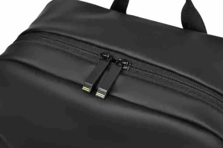 Men's waterproof PU backpack in black with simple sewing thread design and separate computer compartment.