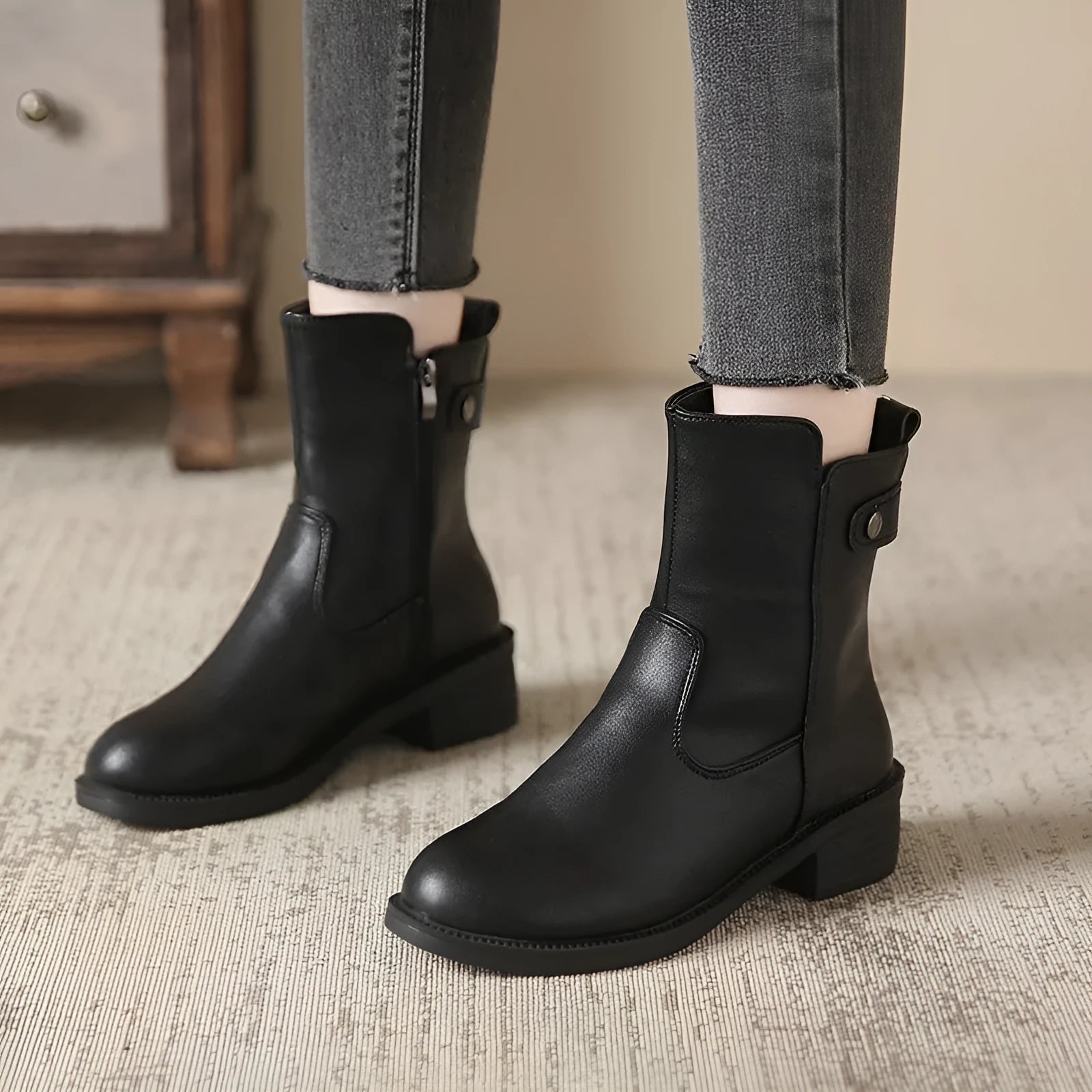 Black women's ankle boots with side zipper and round toe on low rubber heel