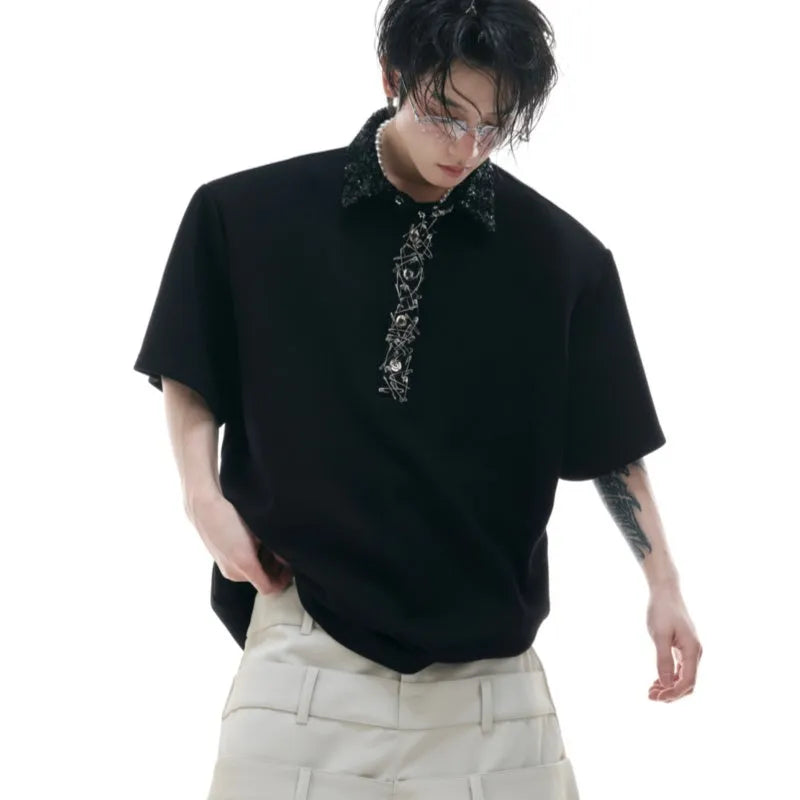 Black men's loose polo t-shirt with heavy embroidery sequins detail on the chest and a square collar.