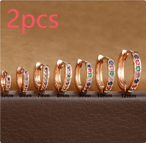 A pair of perforated circle stud earrings in a choice of gold, rose gold, or silver colour.