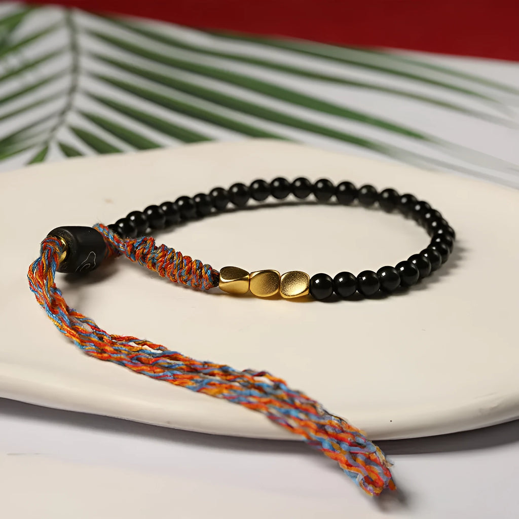 Hand-woven obsidian carrying strap bracelet showing textured detail and adjustable 15.5-16cm length