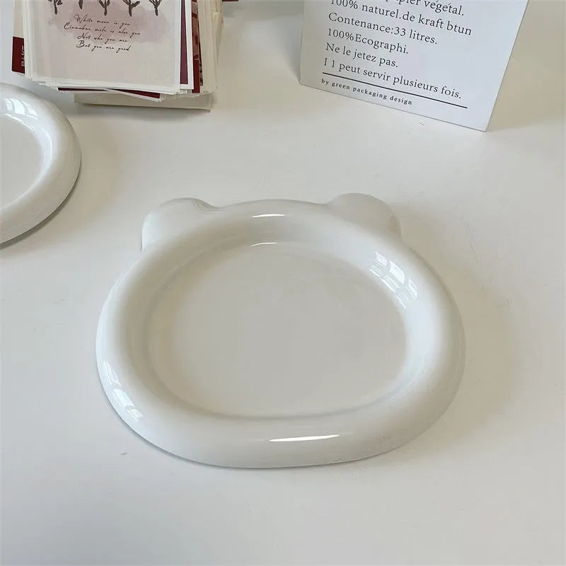 White porcelain plate with cute bear doodle design, 20cm size, on a table.