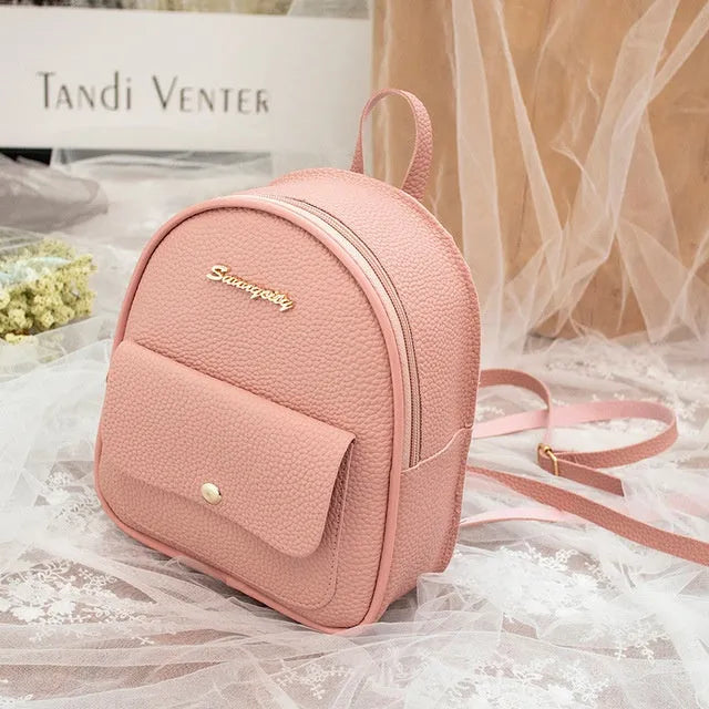 Small black PU shoulder backpack showing front zipper and dimensions