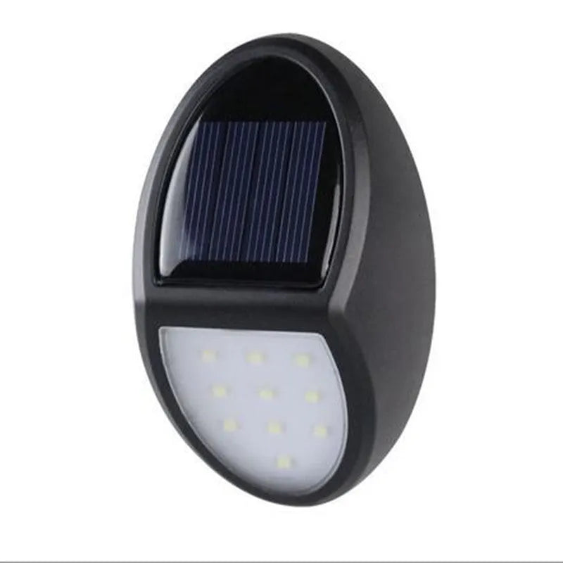Compact black rectangular solar-powered LED wall light mounted on an outdoor wall.