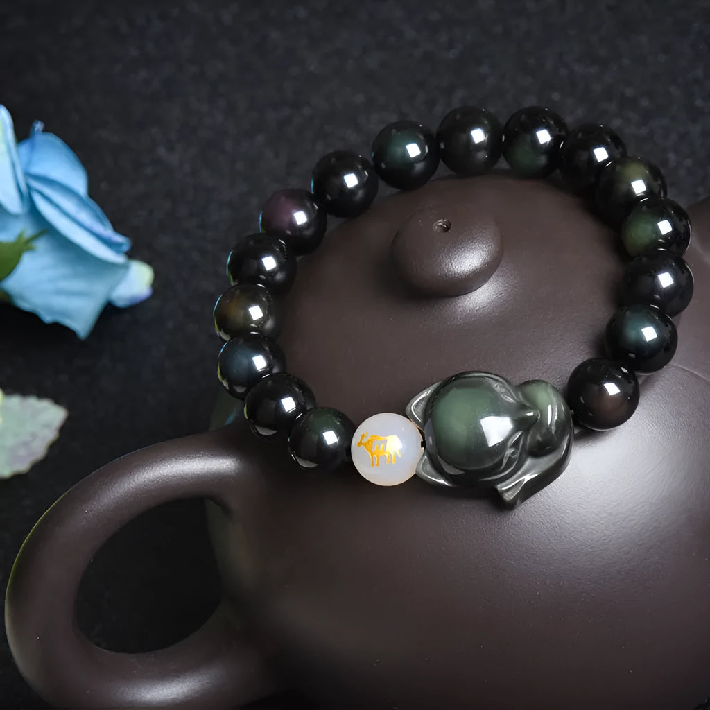 10mm obsidian zodiac bracelet on wrist showing adjustable cord closure and polished stone beads