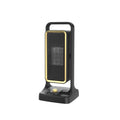 Black compact PTC desktop warm air blower heater with control knob on a desk.
