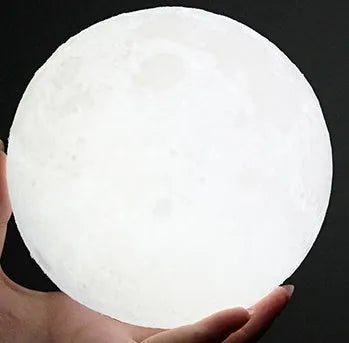 3D-printed white moon lamp on wooden stand with touch-sensitive metal ring base