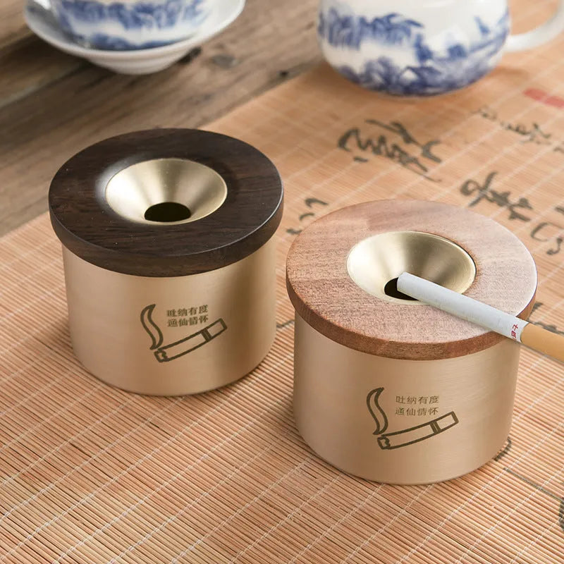 Retro brass ashtray with solid copper construction and hinged wooden lid featuring central circular aperture