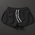 Men's loose polyester beach shorts in black, fluorescent green and orange red colours