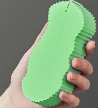 3D white bath sponge with fish scale pattern for gentle body exfoliation.