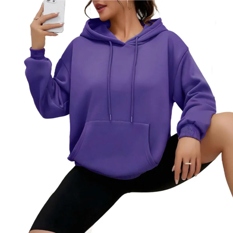 Women's loose grey drawstring pocket sweatshirt with long sleeves on a hanger.