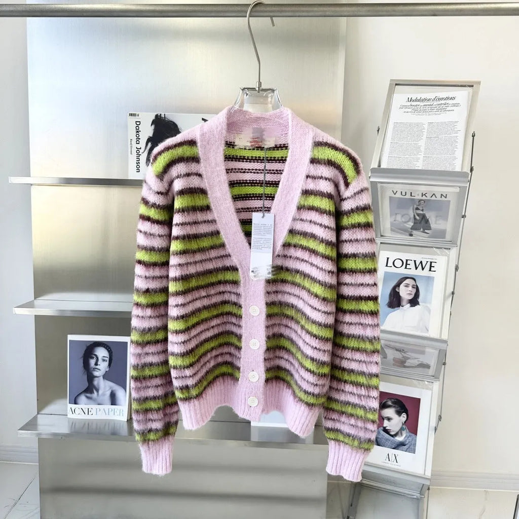 Pink wool knitted cardigan sweater on a hanger, showing round neck and cardigan style options.