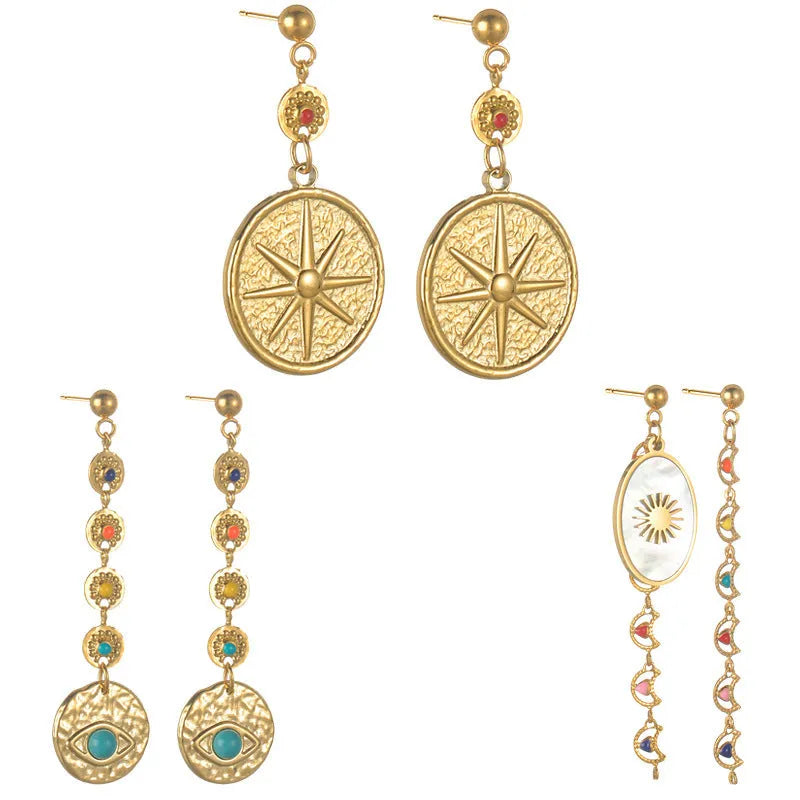 Three pairs of geometric stainless steel earrings showing star, eye and shell sun designs