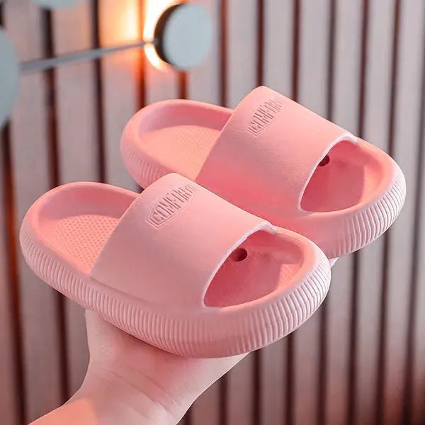 Children's EVA literal slippers with injection moulded soles in mixed colours showing non-slip wear-resistant design