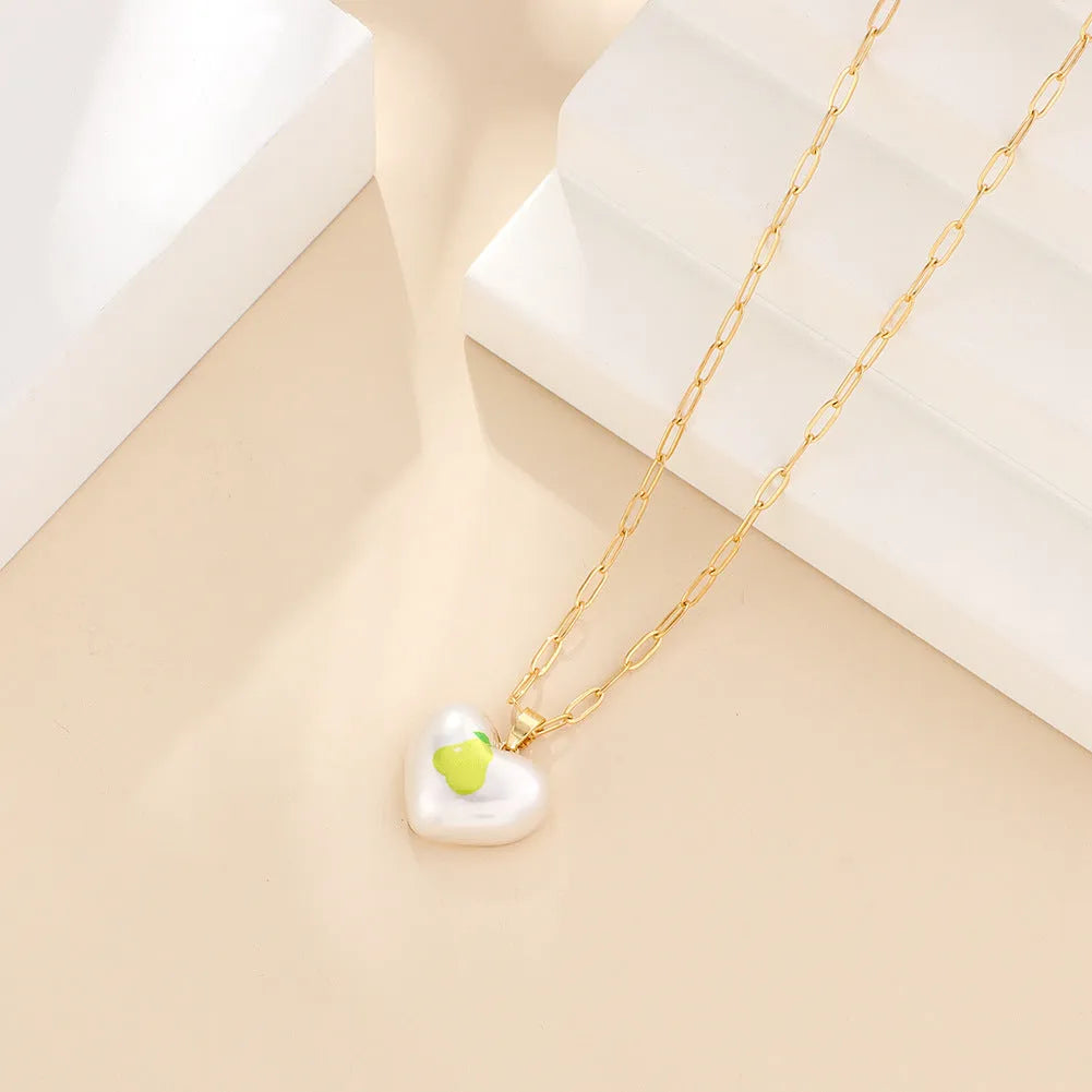 Geometric fruit pendant necklace with adjustable chain showing Apple, Cherry, Pear, Pineapple and Strawberry colour variations