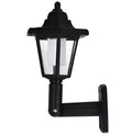 Black hexagonal solar wall lamp with integrated solar panel for outdoor garden or patio lighting