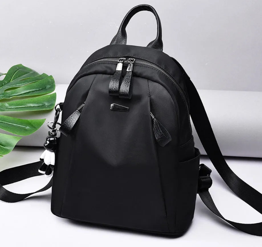 Medium-sized wine red Oxford cloth rucksack showing front view and internal organiser pockets.