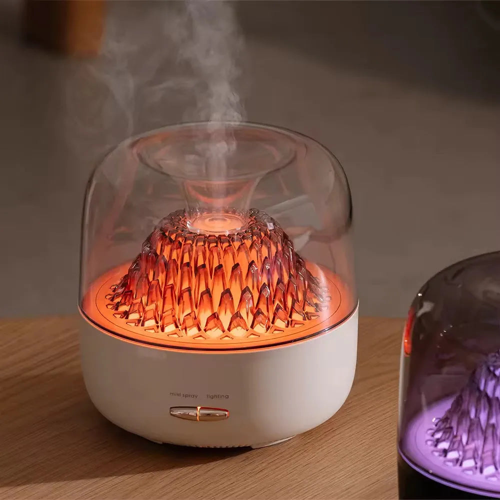 Round resin aroma diffuser in beige on a desk, with mist rising from single outlet, plug-in cord visible