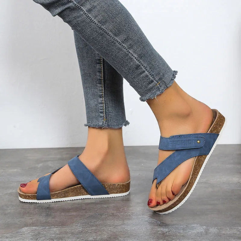 Blue thick-soled flat flip-flops with a toe ring on a foam sole.