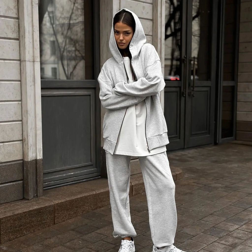 Street style loose fit two-piece set showing long-sleeved coat and matching trousers in solid colour