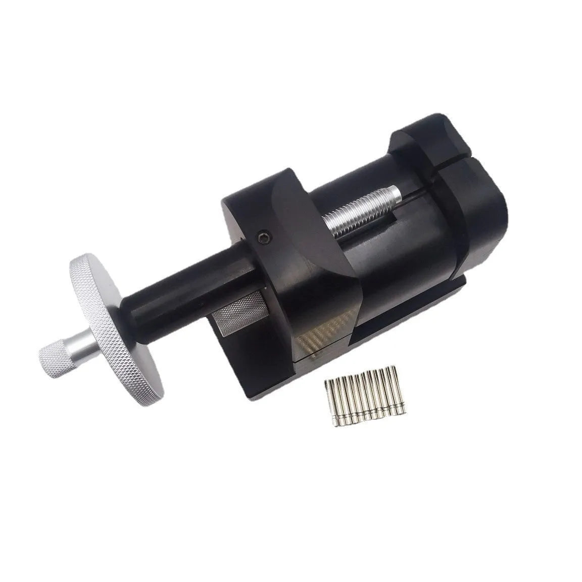 Alloy steel watch strap stripping machine tool for watch repair on a workbench.