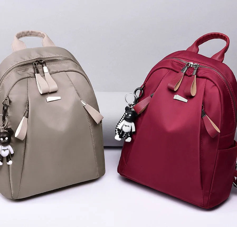 Medium-sized wine red Oxford cloth rucksack showing front view and internal organiser pockets.