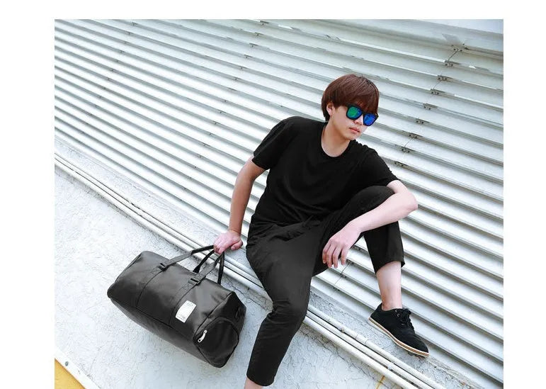 Black waterproof sports bag with separate shoe compartments and diagonal straps in two size options.