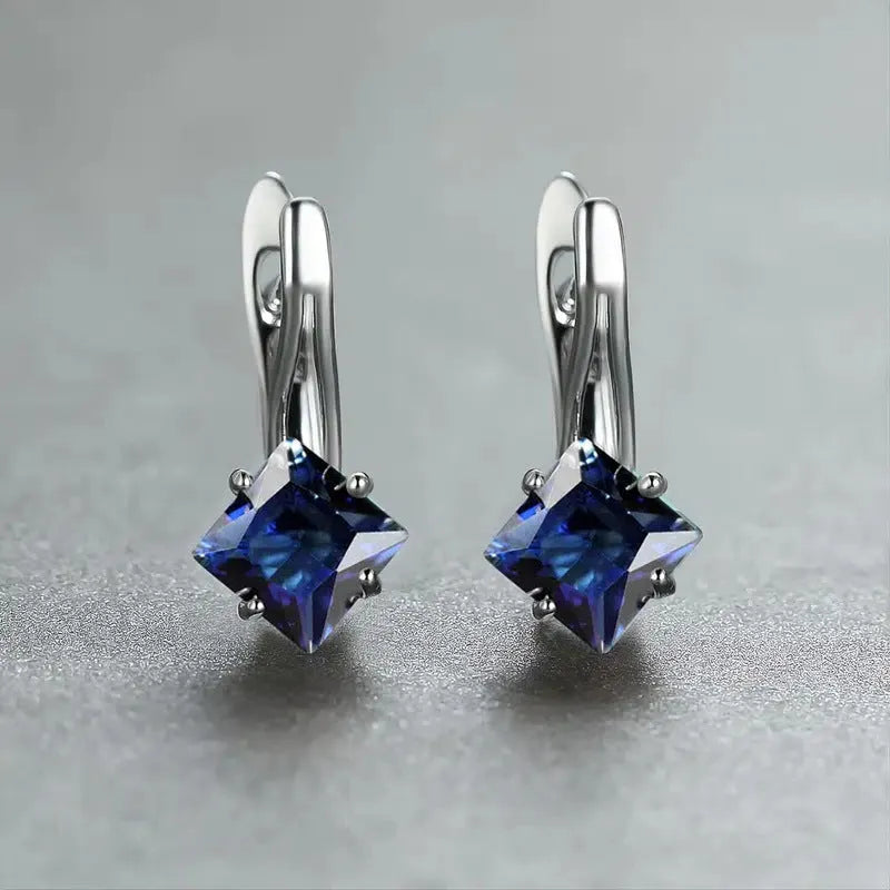 A pair of women's diamond-shaped copper earrings with inlaid zircon stones, shown in a blue colour variant.