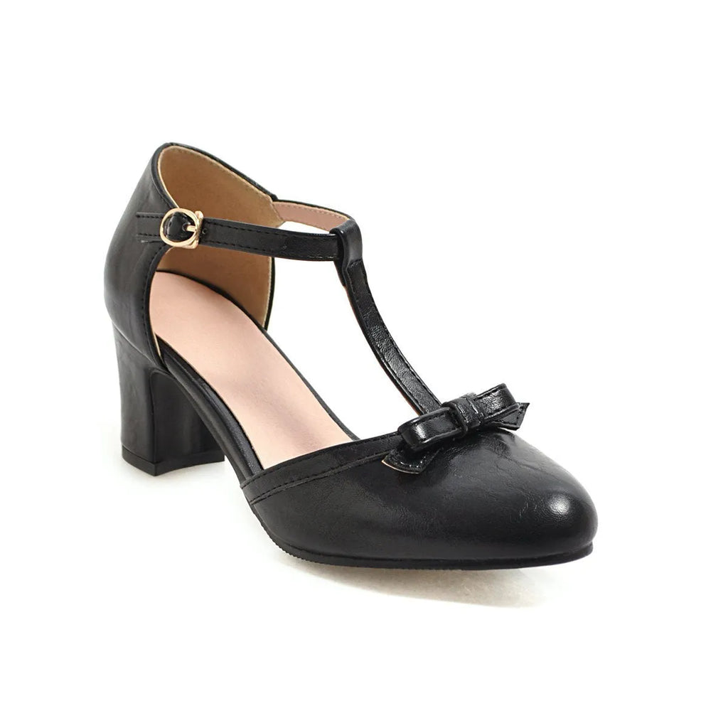 Women's apricot-colour sandals with a chunky heel, bow detail, and a hollow-out buckle strap on a round toe.