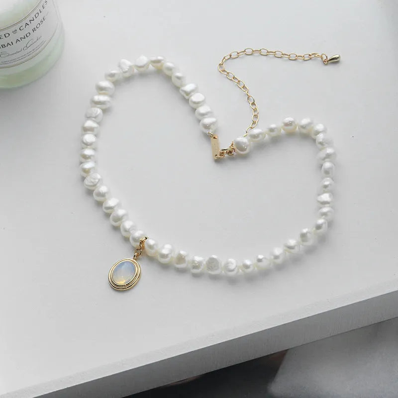 Geometric pearl silver necklace with irregular pearls and adjustable length on white background