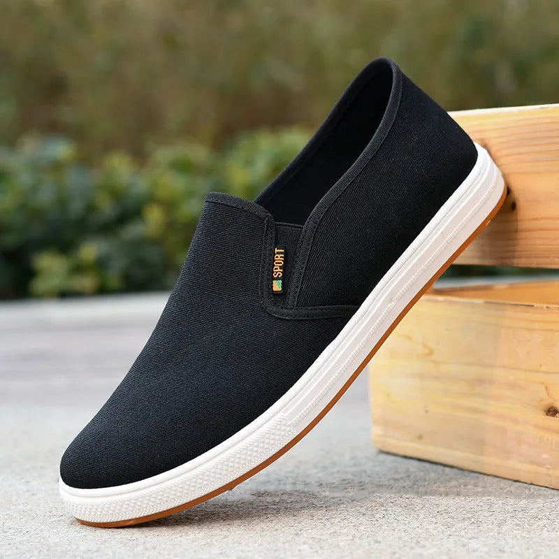 Men's black and blue canvas slip-on shoes with round toe and low-top design