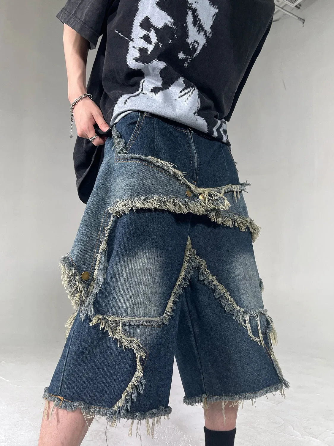 Men's blue denim shorts with five-pointed star embroidery and frayed hem in loose fit style