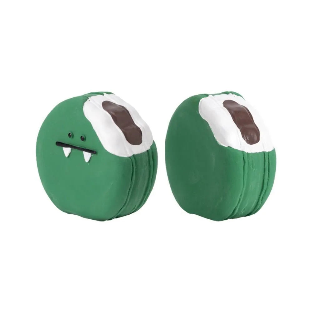 Yellow and green bread-shaped latex dog squeaky toy with cartoon pattern on a white background.