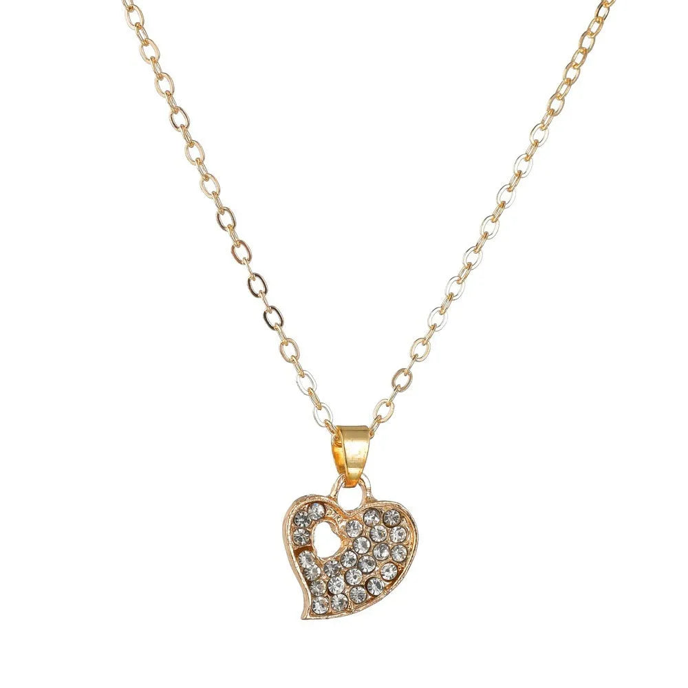 Gold alloy jewellery set with love, water drop and bell charms including earrings, pendant and bracelet