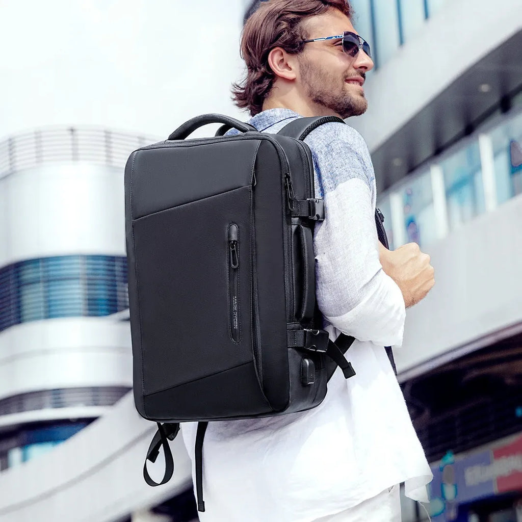 Large black men's backpack with multiple zippered pockets and 36-55 litre capacity