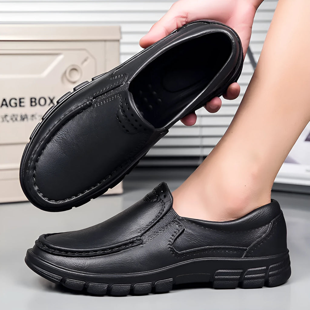 Men's black slip-on work shoes with waterproof platform sole and round toe design