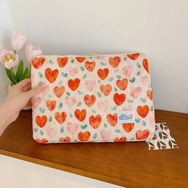 Cloth laptop bag in floral and heart patterns showing three size options with anti-seismic protection