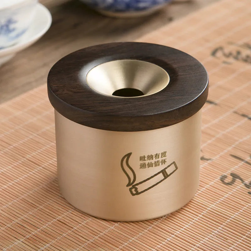 Retro brass ashtray with solid copper construction and hinged wooden lid featuring central circular aperture