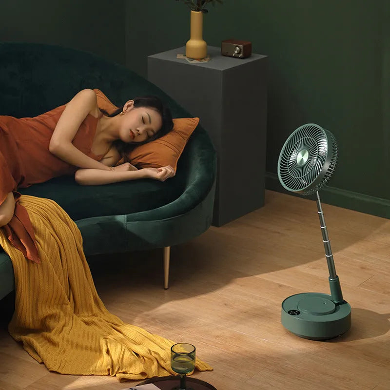 Green telescopic rechargeable electric fan showing extended floor-standing position with remote control