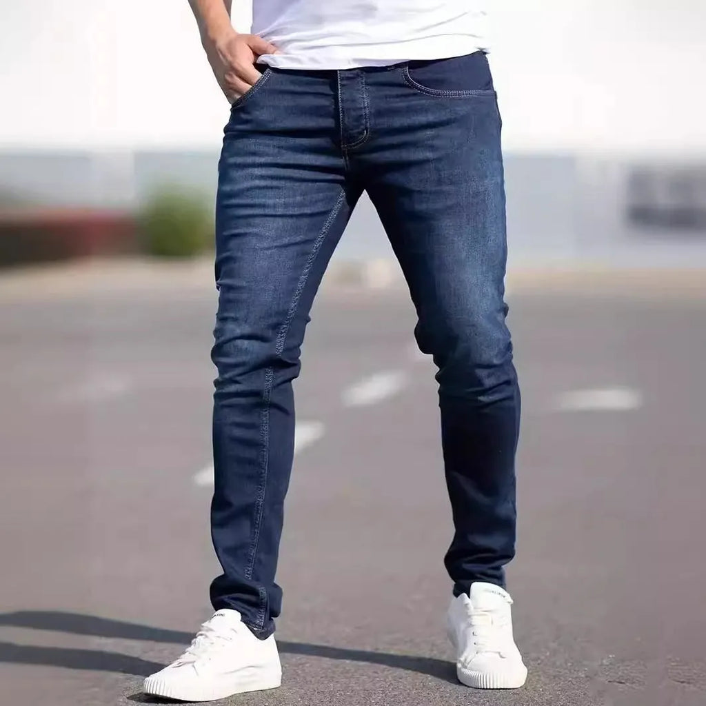 Men's dark blue slim fit casual jeans with skinny leg cut and zipper fly closure