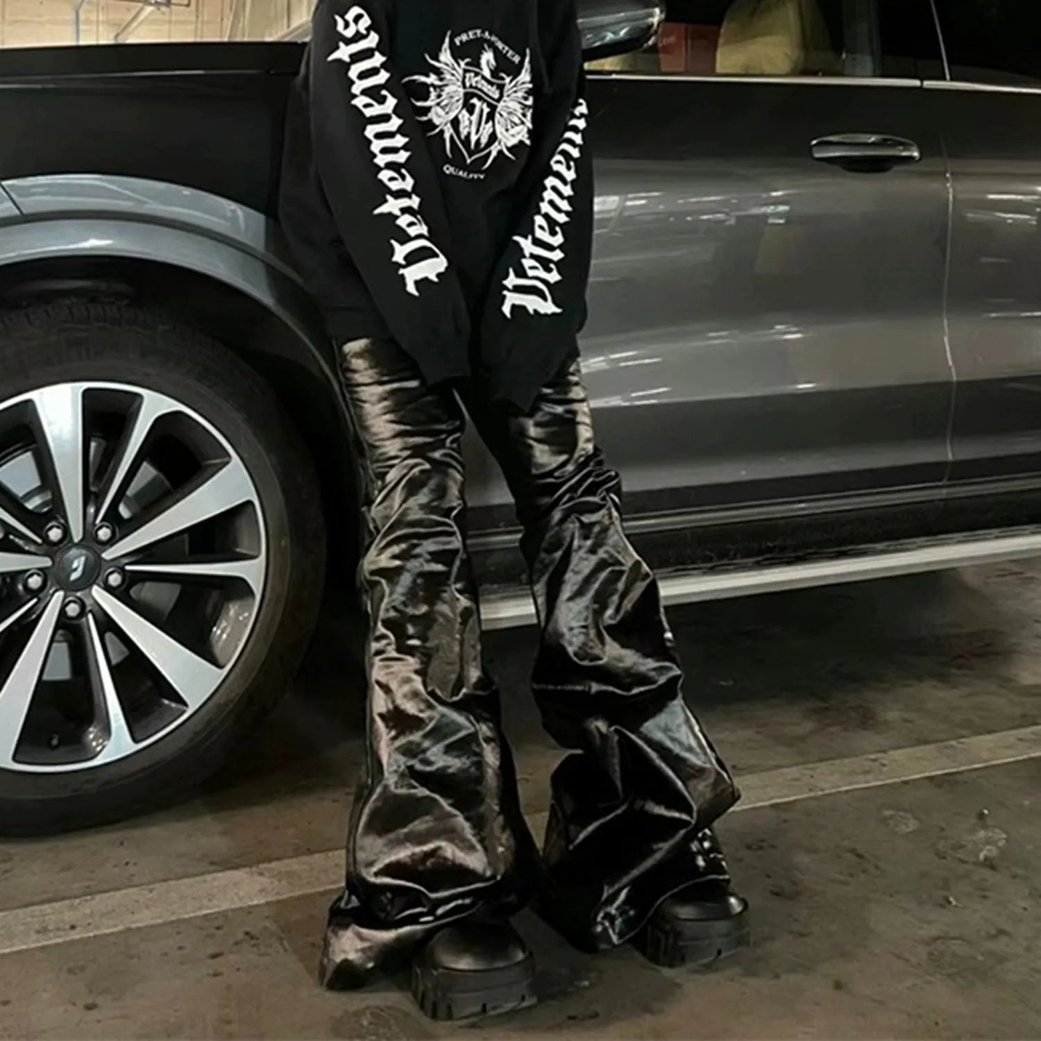 Black women's skinny jeans with a shiny patent leather finish, showing straight-leg cut and mid-rise waist.